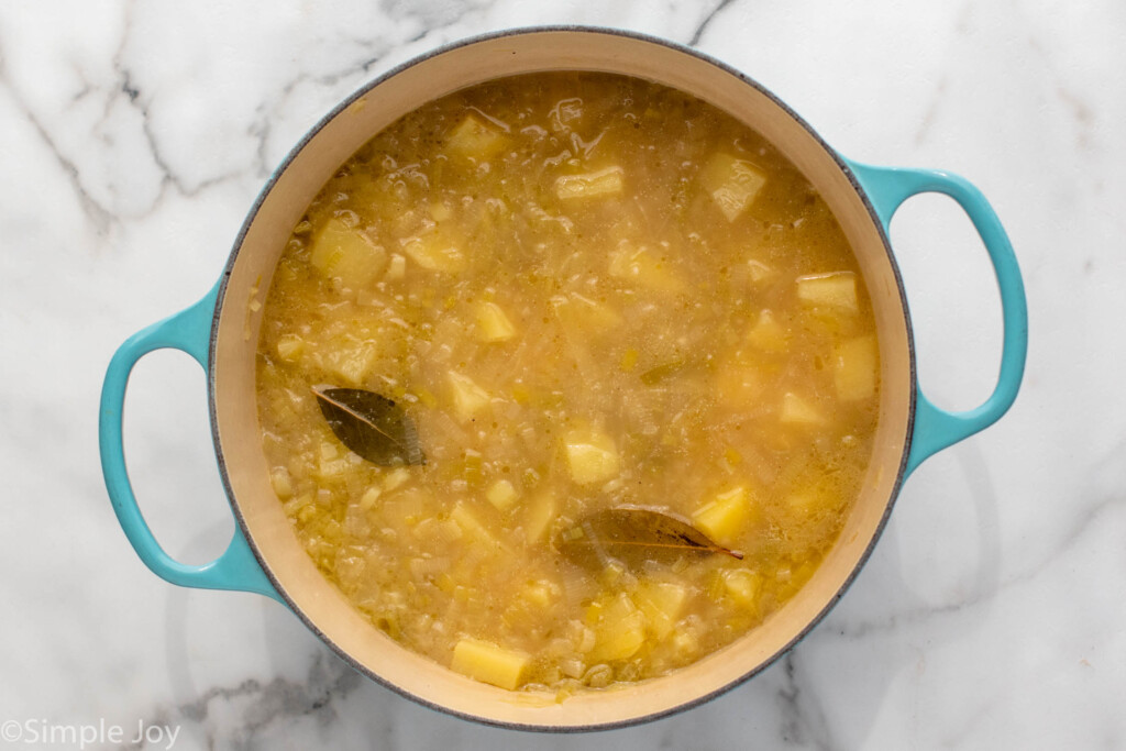 Overhead view of a pot of potato leek soup recipe before blending. - 6