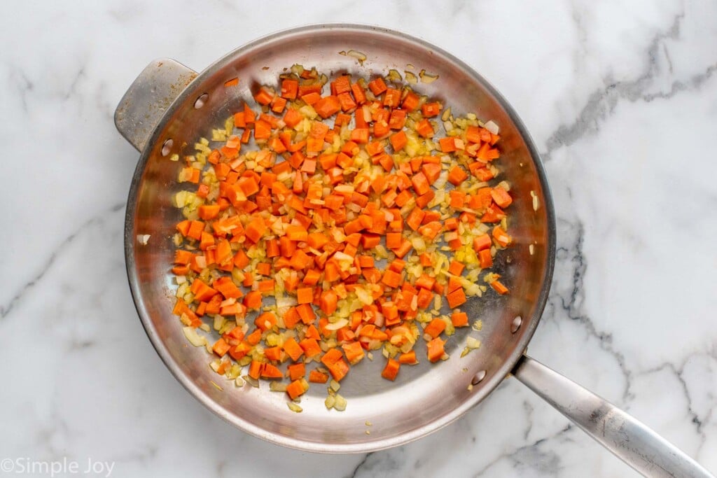 Overhead view of a skillet of carrots and onion for Shepherd's Pie recipe. - 5