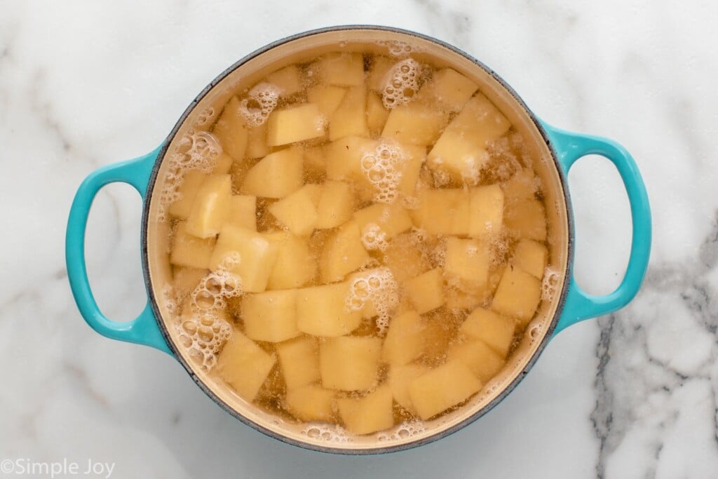 Overhead view of a pot of water and chunks of potatoes for Shepherd's Pie recipe. - 8