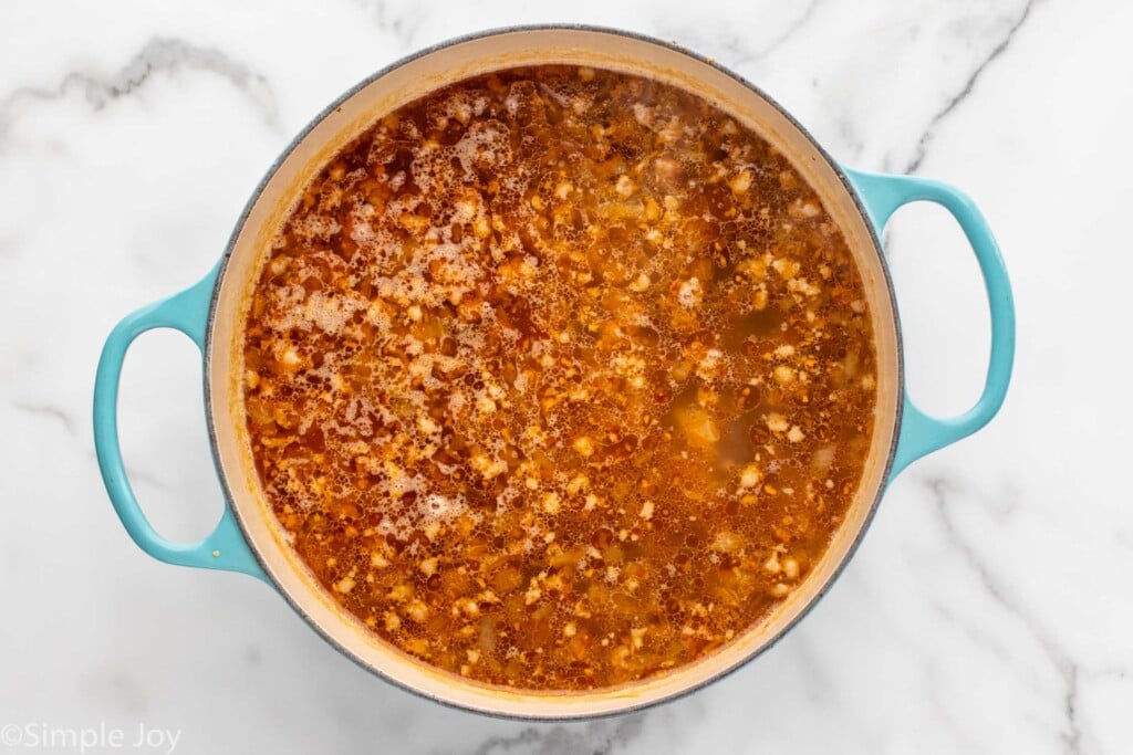 Overhead view of a pot of ingredients for Zuppa Toscana recipe - 8