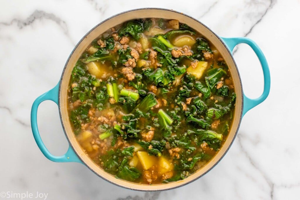Overhead view of a pot of ingredients for Zuppa Toscana recipe - 9