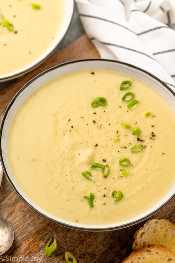 Bowls of potato leek soup garnished with chopped green onions - 3