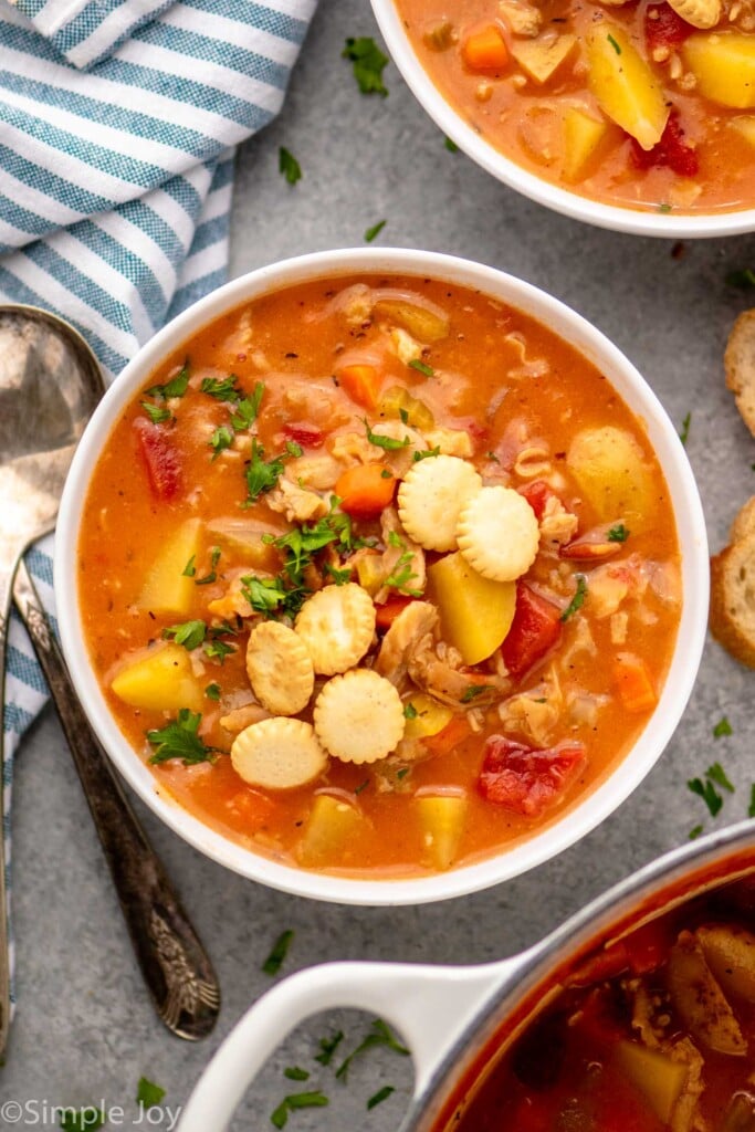 Overhead view of a bowl of Manhattan Clam Chowder with a spoon beside - 11