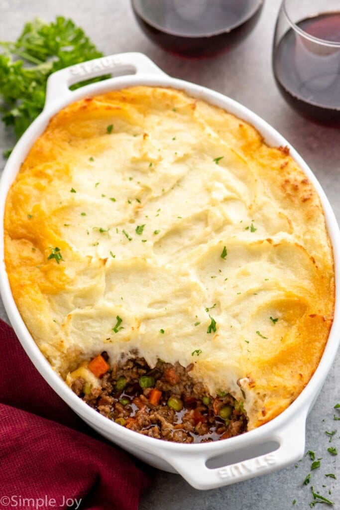 Overhead view of a baking dish with Shepherd's Pie, one piece taken out. - 12