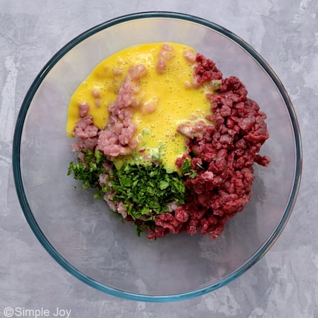 meat, eggs, and parsley in a bowl - 4