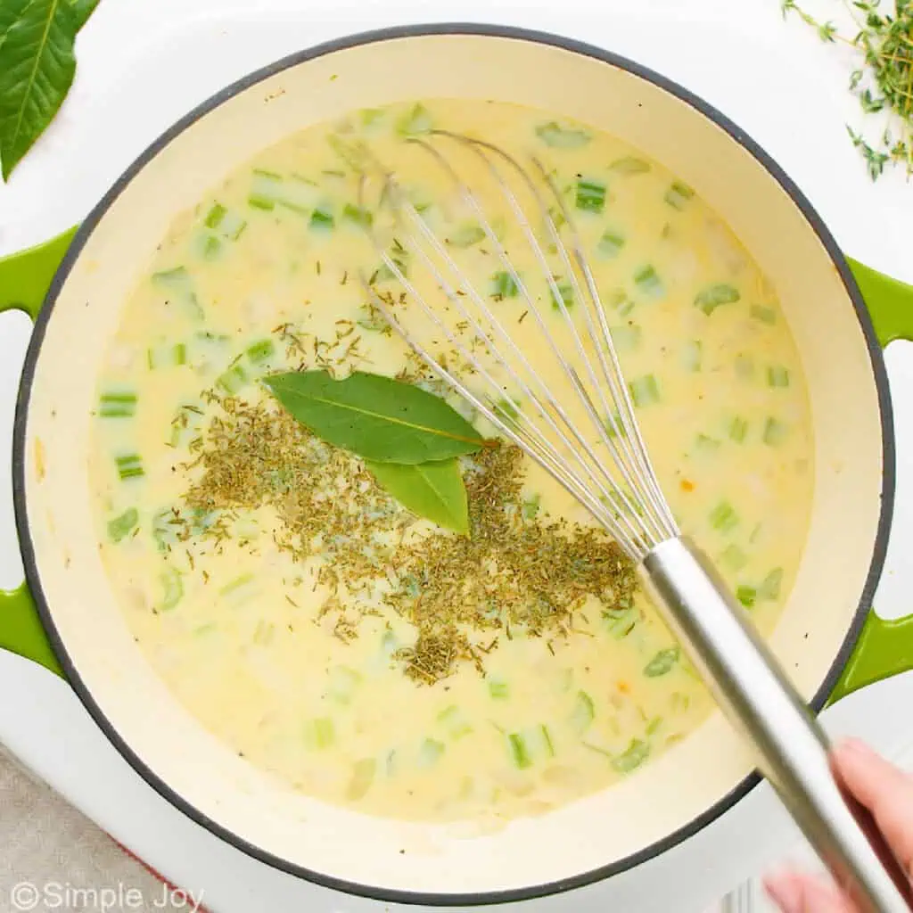 adding seasonings to a broth