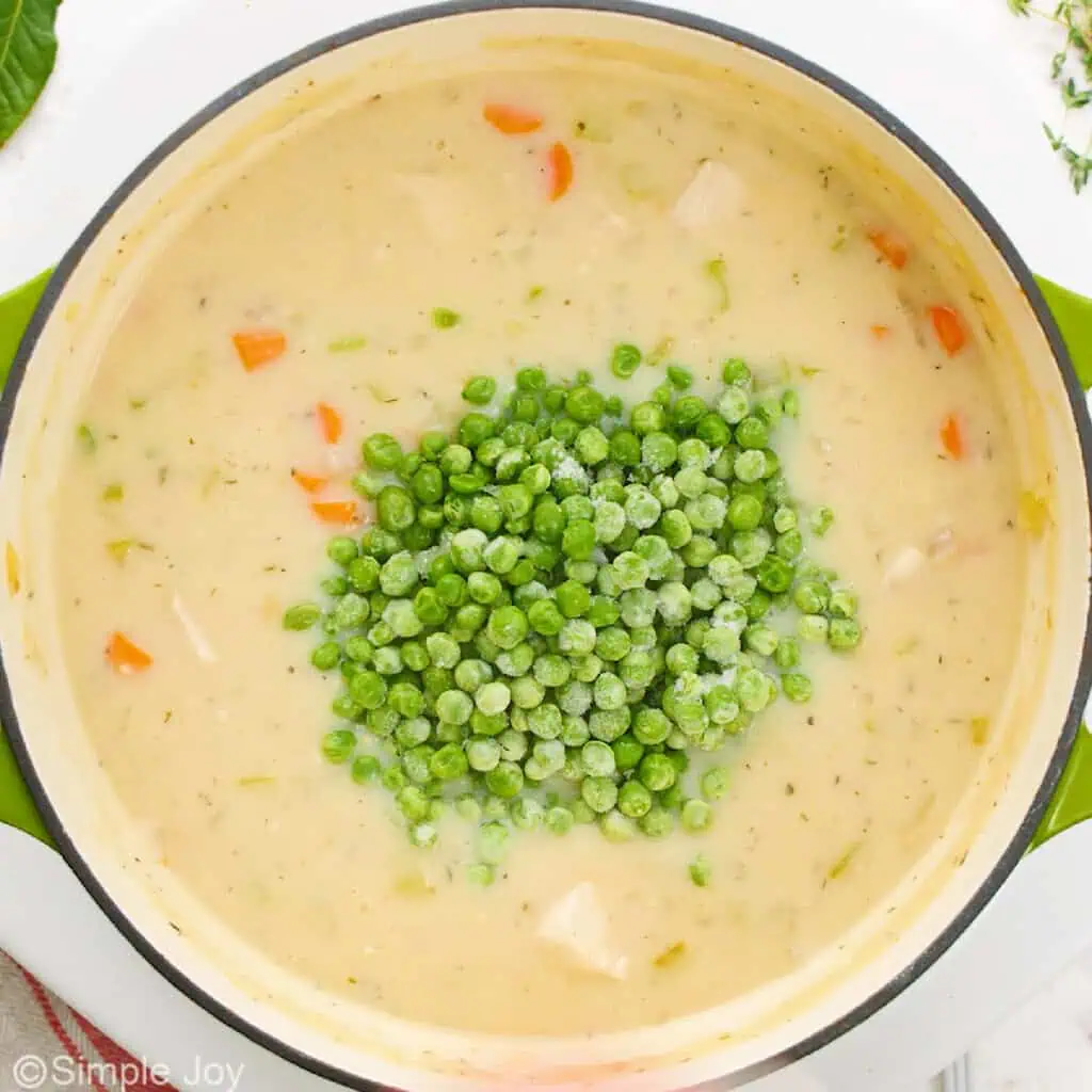 adding frozen peas to a broth