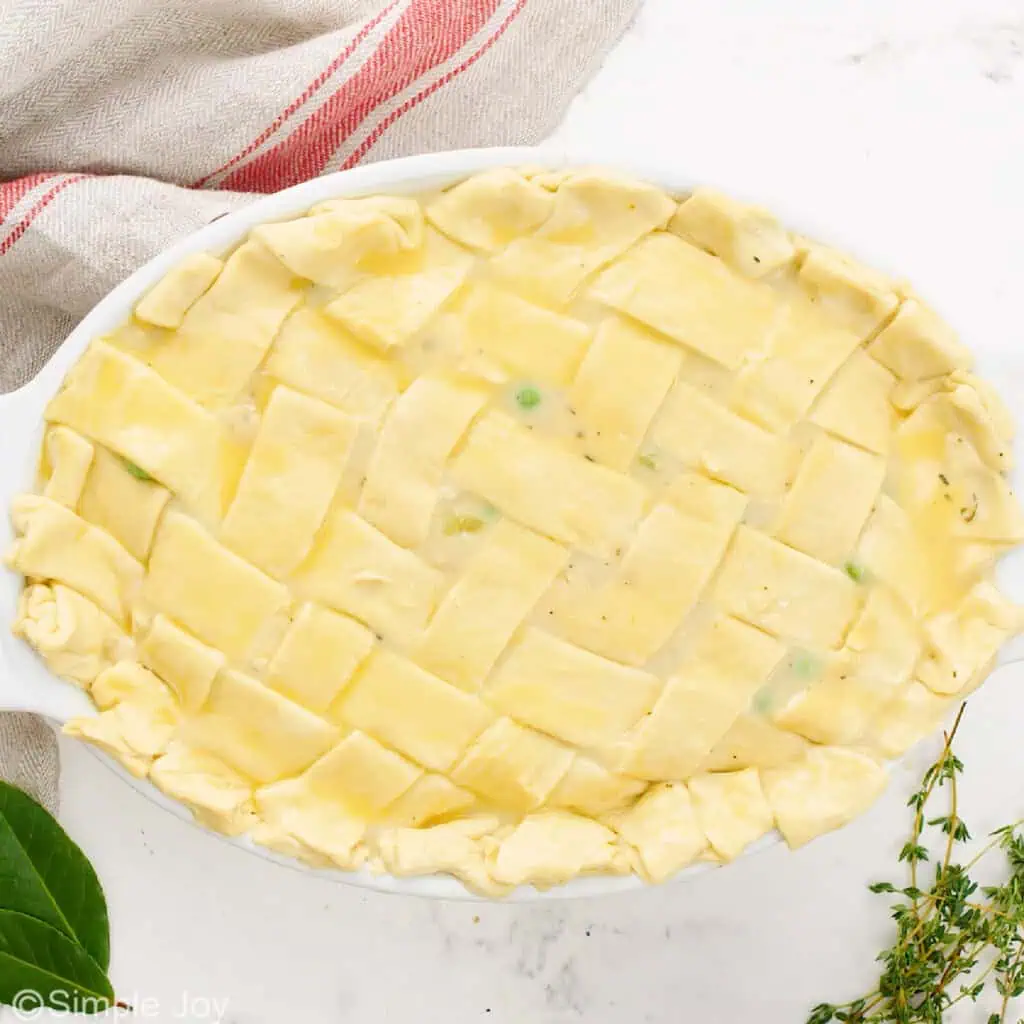 unbaked puff pastry on the top of a chicken pot pie casserole