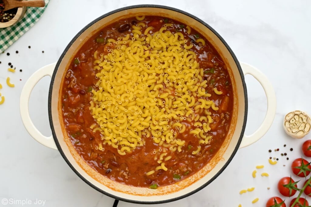 dry pasta added to a pot to make chili Mac - 9