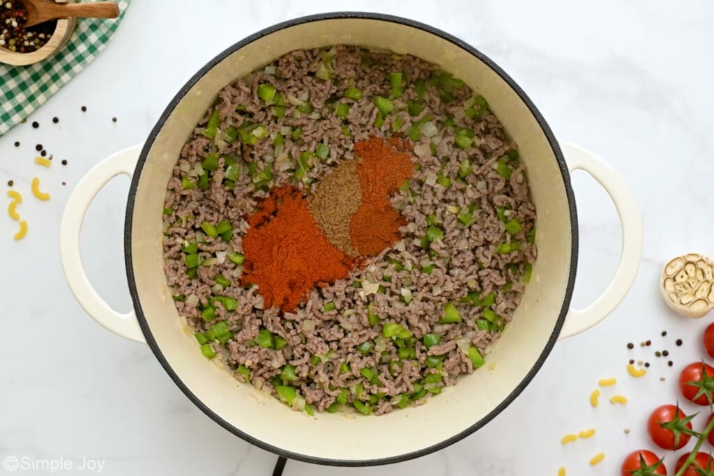 spices added to a pot of cooked ground beef and vegetables - 7