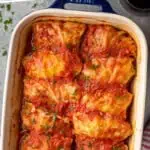 Pinterest graphic for Stuffed Cabbage Rolls recipe. Text says, "the best cabbage rolls simplejoy.com." Image shows overhead view of a baking dish of Stuffed Cabbage Rolls recipe.