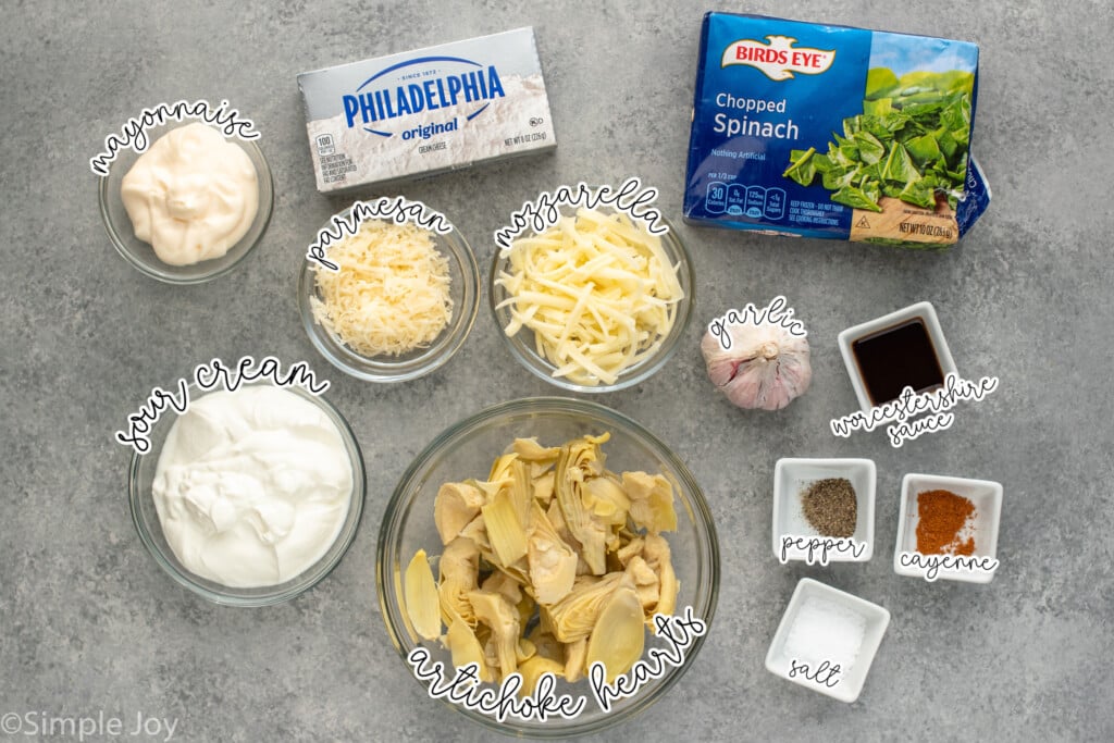Overhead view of ingredients for Crockpot Spinach Artichoke Dip recipe on countertop. - 5
