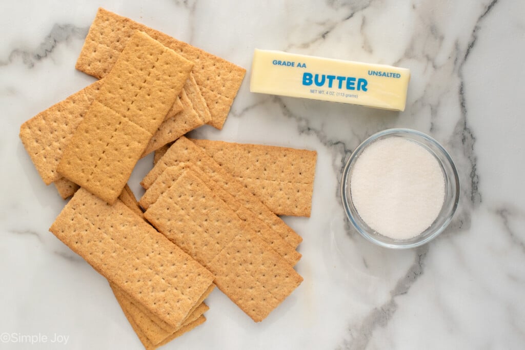 Overhead view of ingredients on countertop for graham cracker crust recipe. - 5