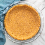 Overhead view of graham cracker crust in a pie plate