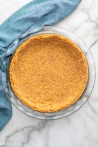 Overhead view of graham cracker crust in a pie plate - 10