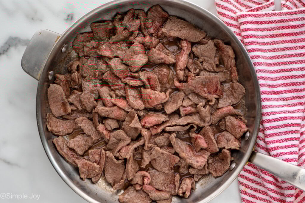 Overhead view of a skillet of beef cooking for easy Beef and Broccoli recipe