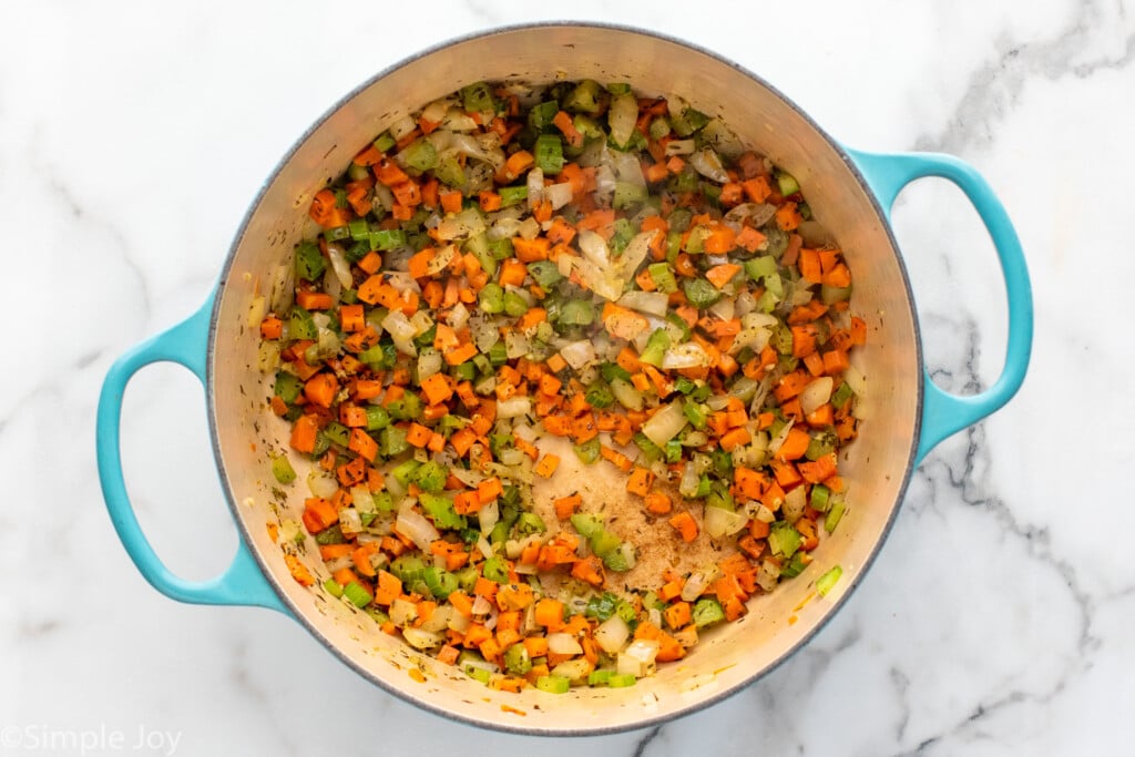 Overhead view of pot of seasoned chopped vegetables for chicken gnocchi soup recipe.