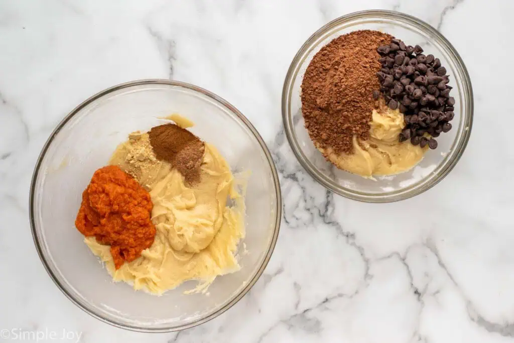 Overhead view of a mixing bowls of ingredients for two different types of batter for Pumpkin brownies recipe