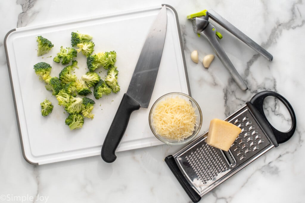 Overhead view of ingredients and kitchen supplies on countertop for Sausage Broccoli Pasta recipe. - 6