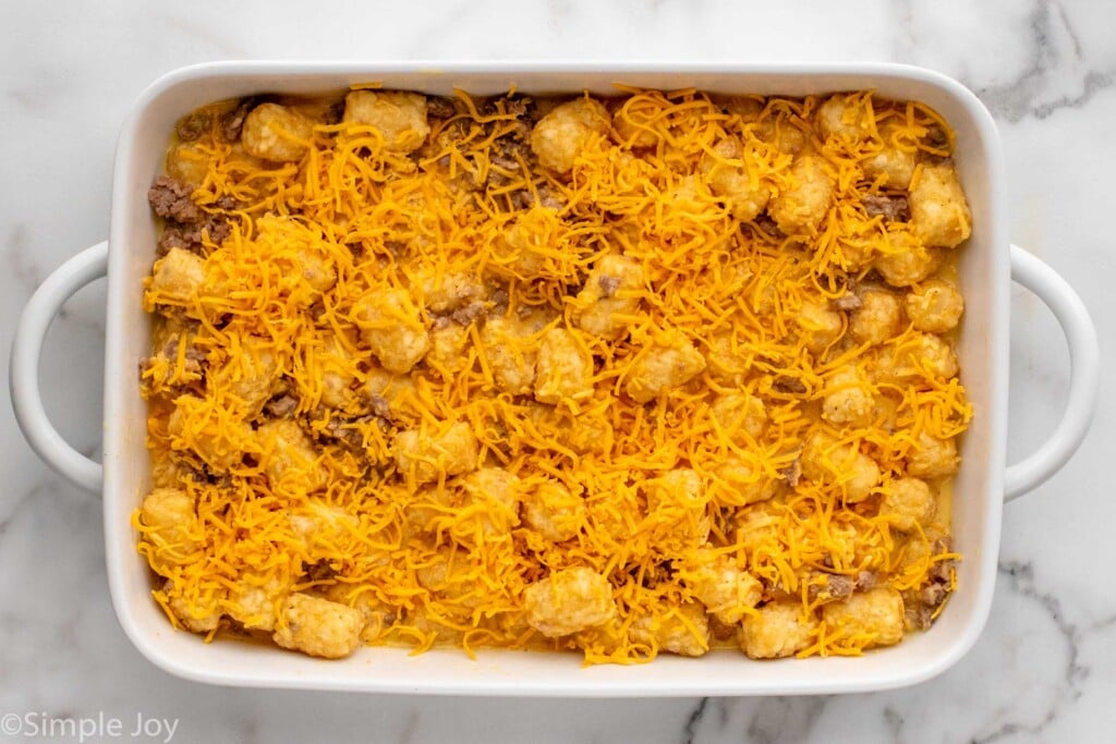 Overhead view of a baking dish of tater tot breakfast casserole recipe before baking