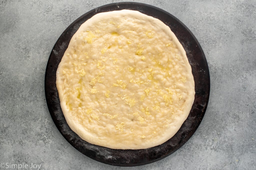 Overhead view of a baked crust for White Pizza recipe. - 5