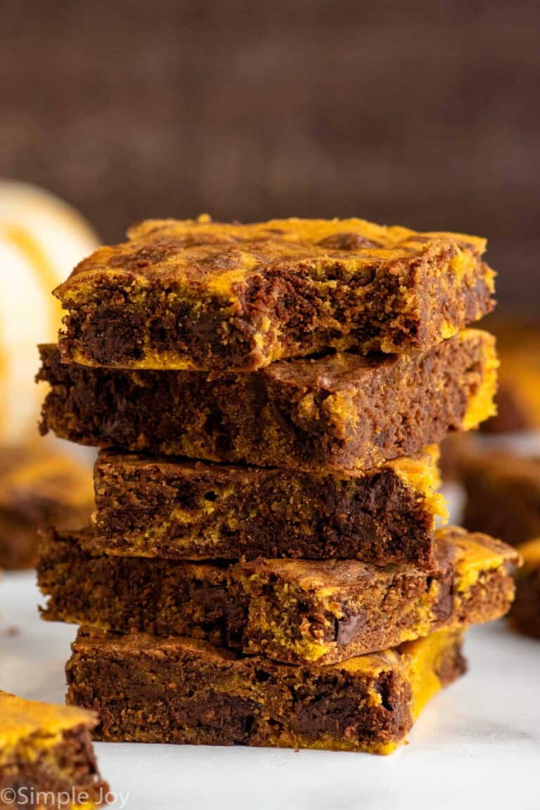 Close up side view of a stack of Pumpkin brownies with a bite taken out of the top brownie