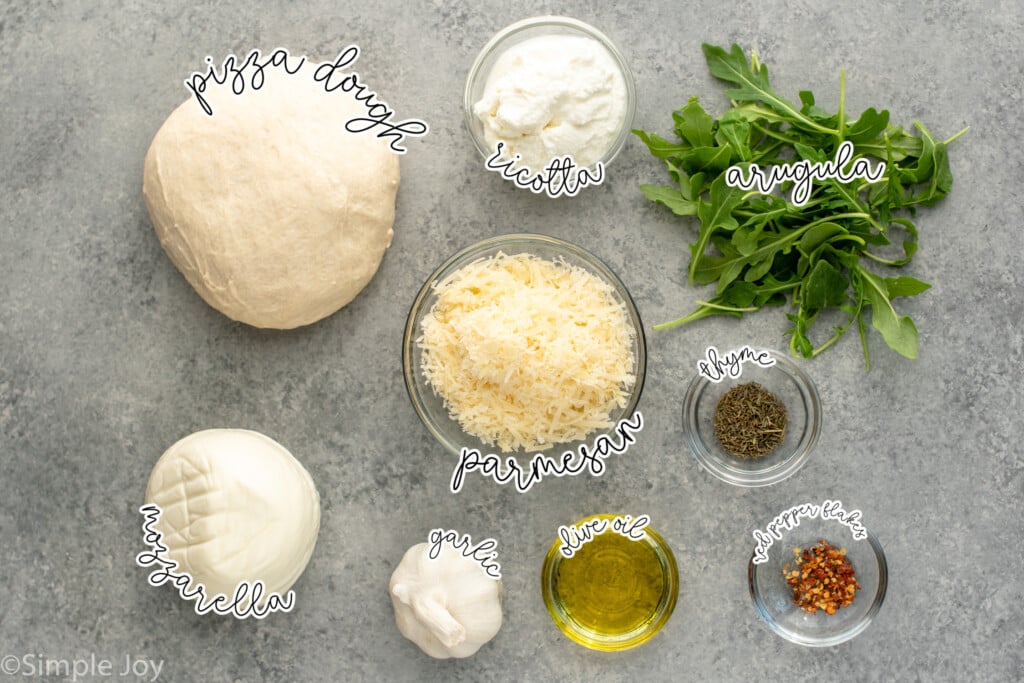 Overhead view of ingredients on countertop for White Pizza recipe. - 3
