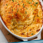 Pinterest graphic for Potatoes Au Gratin recipe. Image shows overhead view of baking dish of Potatoes Au Gratin with some taken out. Text says, "Potatoes Au Gratin simplejoy.com."
