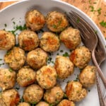 Pinterest graphic for Baked Turkey Meatballs recipe. Text says, "the best turkey meatballs simplejoy.com." Image is overhead view of a bowl of Baked Turkey Meatballs with forks.