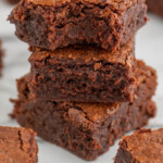 Pinterest graphic for Fudgy Brownie Recipe. Image shows side view of stack of Fudgy Brownies. Text says, "the best fudgy brownies simplejoy.com."