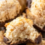 Pinterest graphic for Coconut Macaroons recipe. Text says, "the best Coconut Macaroons simplejoy.com." Image shows close up view of Coconut Macaroons with bite taken out of top Coconut Macaroon