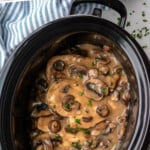 Pinterest graphic for Crock Pot Chicken Marsala recipe. Text says, "slow cooker chicken marsala simpejoy.com." Image shows overhead view of slow cooker of Crock Pot Chicken Marsala recipe.