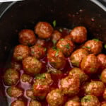 Pinterest graphic for Grape Jelly Meatballs recipe. Text says, "3 ingredient Grape Jelly Meatballs simplejoy.com." Image shows crockpot of Grape Jelly Meatballs garnished with parsley.