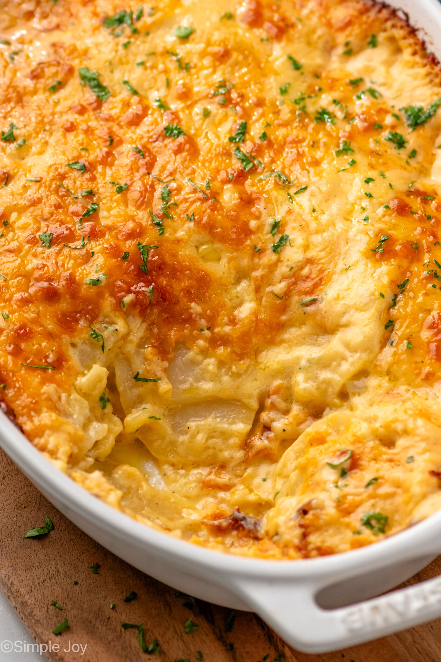 Baking dish of Potatoes Au Gratin with portion taken out.