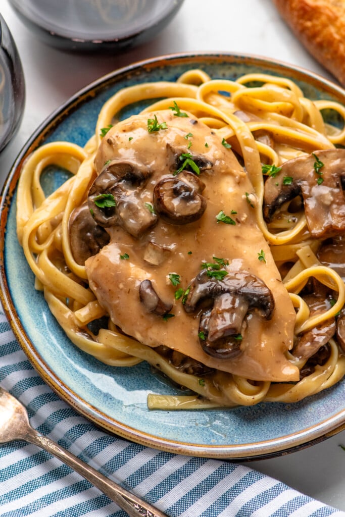 Crock Pot Chicken Marsala served with fettuccini on a plate. - 3