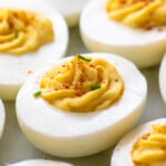 Close up of Deviled Eggs garnished with paprika and chopped chives - 19