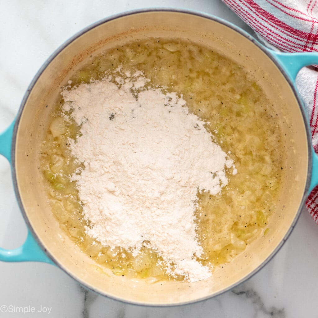 Overhead view of a pot of ingredients and flour for Potatoes Au Gratin recipe - 6