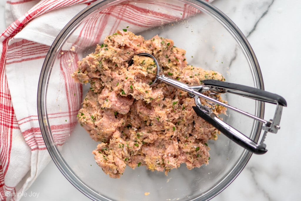 Overhead view of a mixing bowl of Baked Turkey Meatballs recipe mixed together with a cookie scoop - 5