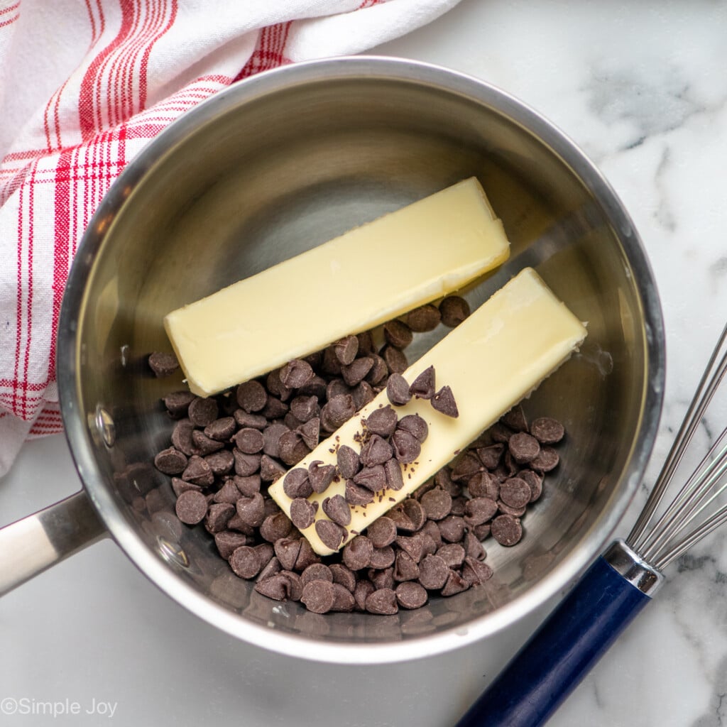 Overhead view of a saucepan with butter and chocolate chips for Fudgy Brownie Recipe, whisk beside - 8