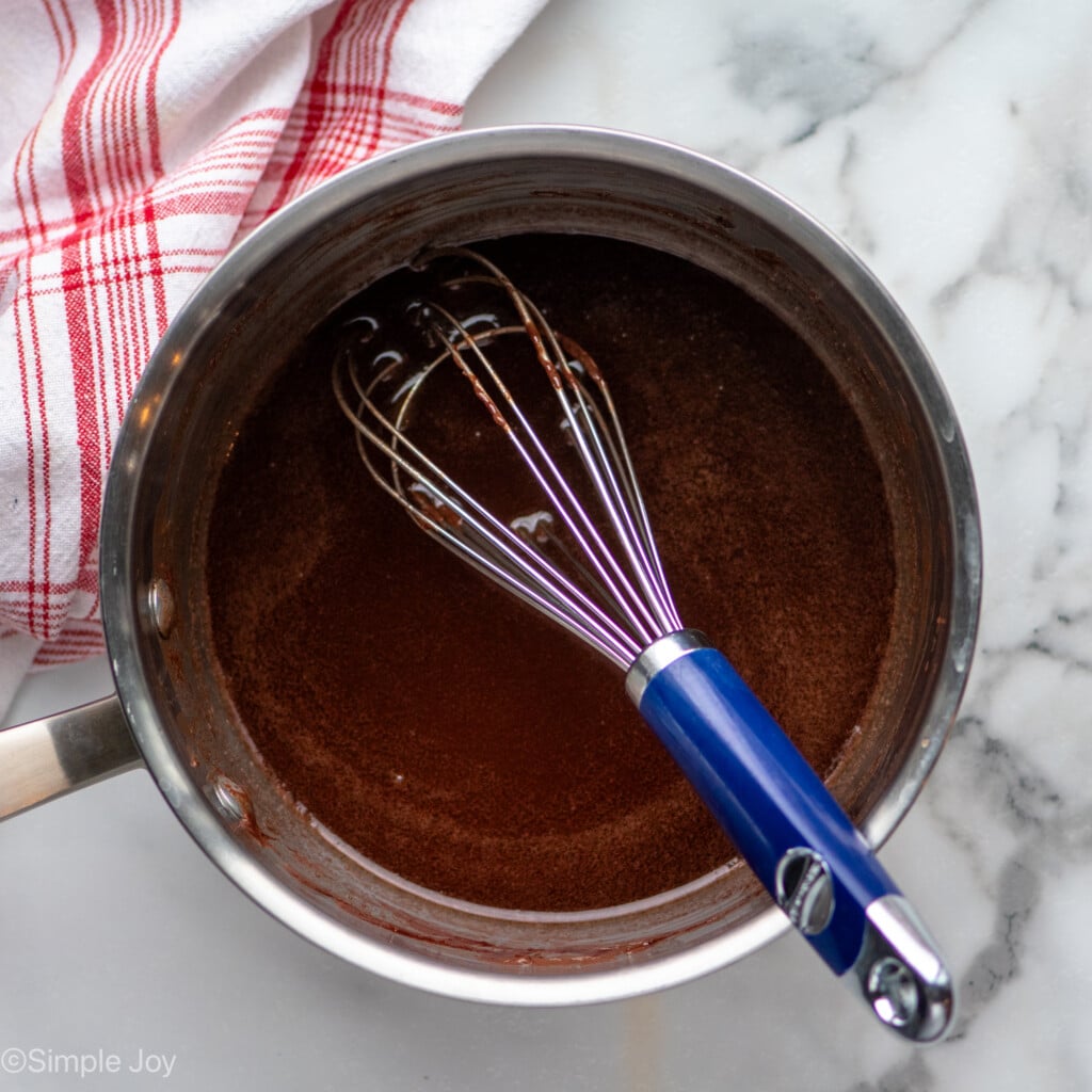 Overhead view of saucepan of ingredients for Fudgy Brownie Recipe with whisk