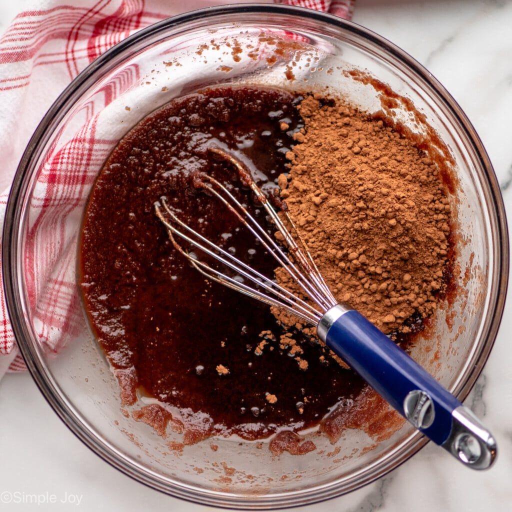 Overhead view of glass mixing bowl with ingredients and whisk for Fudgy Brownie Recipe