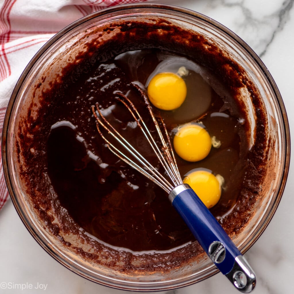 Overhead view of a mixing bowl of ingredients and whisk for Fudgy Brownie Recipe - 10