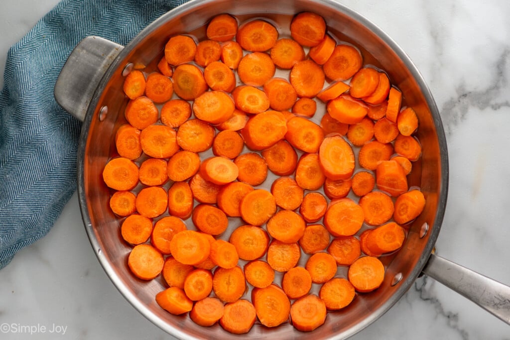Overhead view of a skillet of chopped carrots for candied carrots recipe - 6