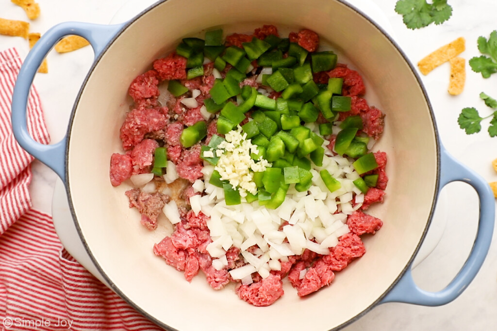 overhead of large pot of ground beef, diced green pepper, onion, and garlic to make easy chili recipe - 7