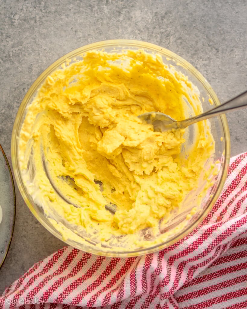 Overhead view of mixing bowl of filling for Deviled Eggs recipe with spoon - 7