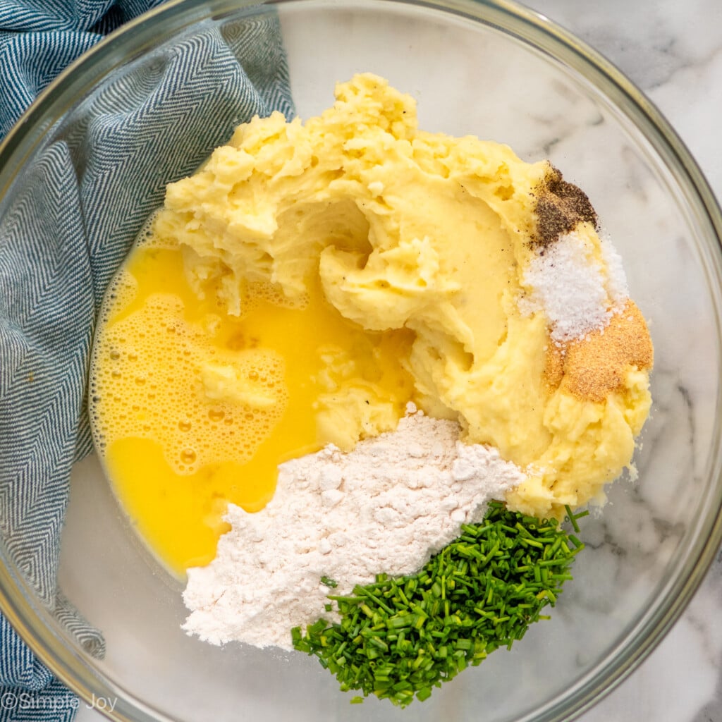 Overhead view of a bowl of ingredients for Mashed Potato Pancakes before mixing - 5