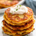 Stack of Mashed Potato Pancakes topped with sour cream and chopped chives