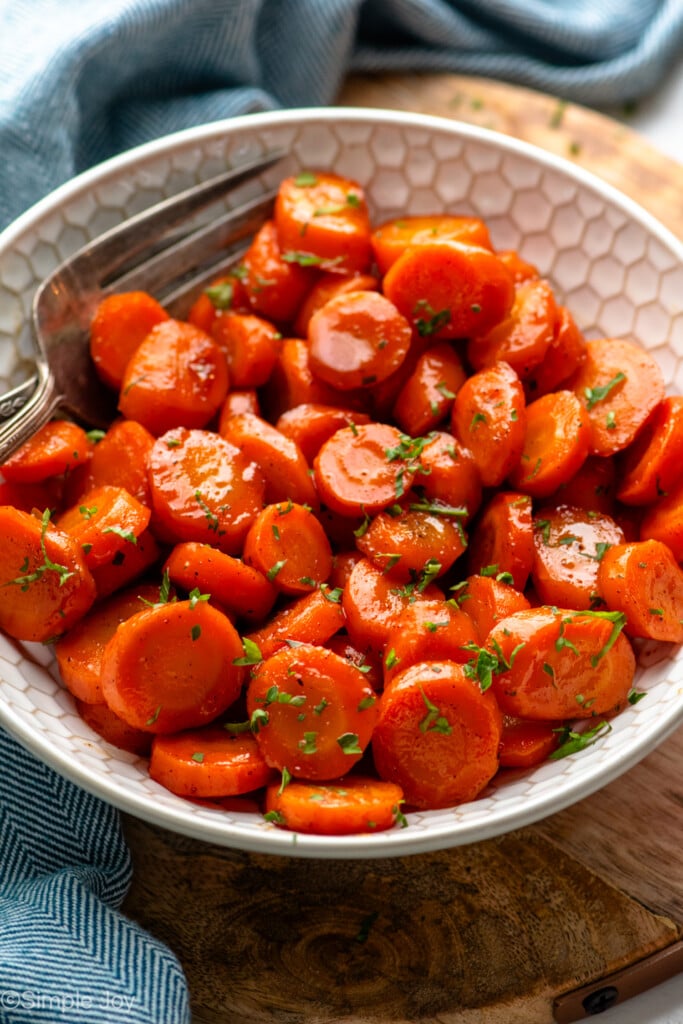 Bowl of candied carrots with forks - 10