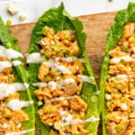 Pinterest graphic for Buffalo Chicken Salad recipe. Text says, "Buffalo Chicken Salad simplejoy.com. Image shows overhead view of lettuce topped with Buffalo Chicken Salad, garnished with blue cheese crumbles and chopped green onions, dressing.