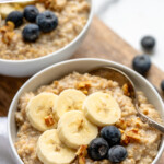 Pinterest graphic for Instant Pot Steel Cut Oats recipe. Text says, "Instant Pot Steel Cut Oats simplejoy.com." Image shows bowls of Instant Pot Steel Cut Oats topped with banana slices and blueberries, spoons for eating.